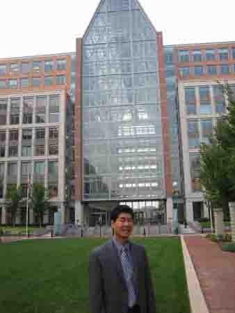 Clement Cheng standing in front of the U.S. Patent and Trademark Office building